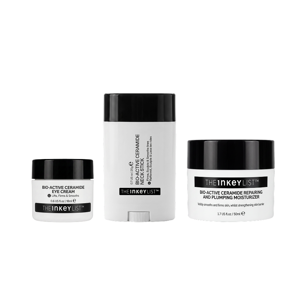 Three skincare products from The Inkey List on a plain white background: a small eye cream jar, a tall cream stick, and a moisturizer jar. The containers are white with black lids and black label bands.