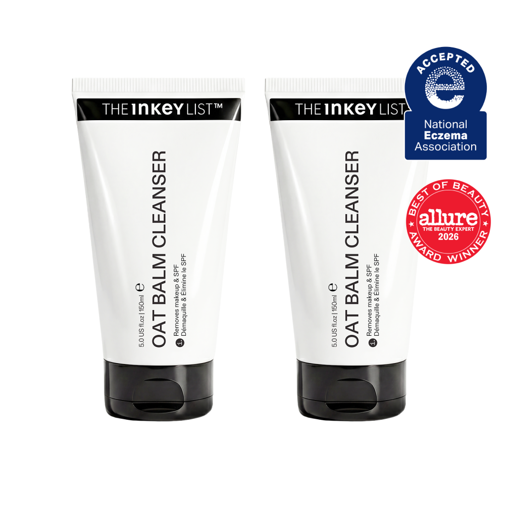 Two white tubes of OAT BALM CLEANSER by THE INKEY LIST with black caps, shown side by side on a white background with a blue and red award badge on the right.